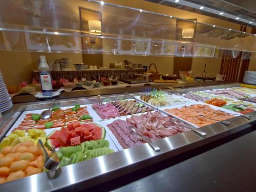 a buffet line with many different types of food at Hotel Friesische Wehde in Bockhorn