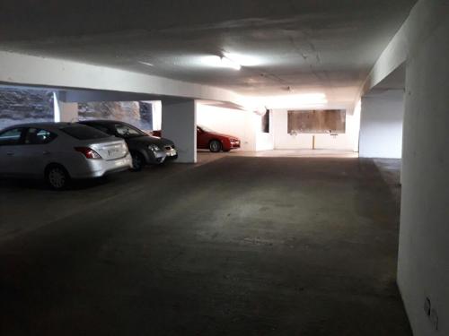 a parking garage with two cars parked in it at Departamento vista al mar in Valparaíso