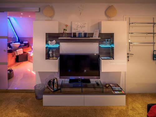 a living room with a large screen tv on a table at Gästezimmer Im Haus Am Wald in Freudenstadt