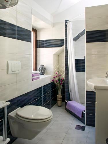 a bathroom with a toilet and a sink at Villa Toni Design Apartments in Split