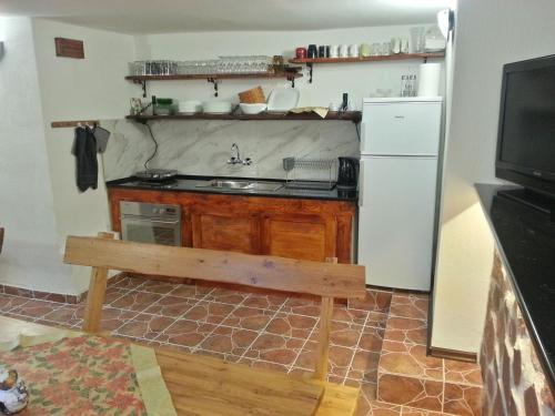 a kitchen with a sink and a stove and a refrigerator at Guest House Bedrock in Belogradchik