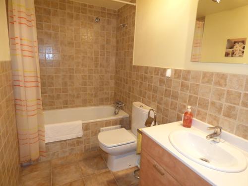 a bathroom with a sink and a toilet and a tub at Nature Appartements Font Romeu in Font-Romeu