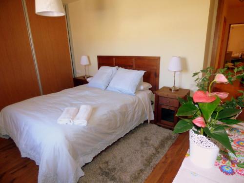 a bedroom with a bed with two towels on it at Nature Appartements Font Romeu in Font-Romeu
