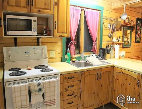 a kitchen with a stove and a sink at The Gingerbread Cabin in Jasper