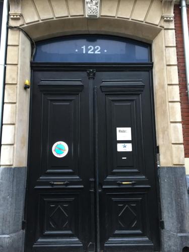 a large black door with a sign on it at Luxueux logement Bourgeois de 250 M2 climatisé in Lille