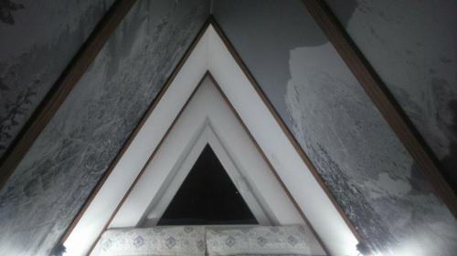 a framed picture of a triangle on a wall at Apartament Palisander in Kościelisko