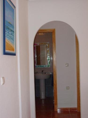a bathroom with a sink and a mirror at Bungalow Arenales del Sol, Alicante in Arenales del Sol