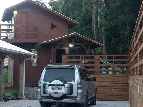 a car parked in front of a house at Pousada Farol do Arvoredo in Governador Celso Ramos