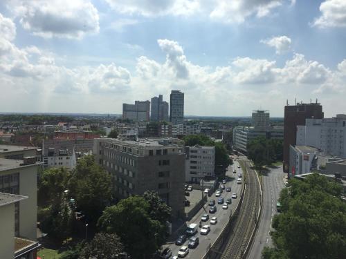 a view of a city with cars on a highway at Madame Tower in Cologne
