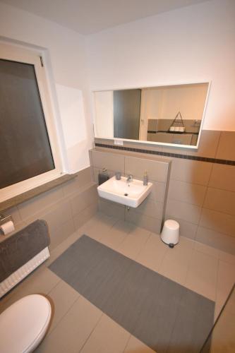 a bathroom with a sink and a mirror at Madame Tower in Cologne