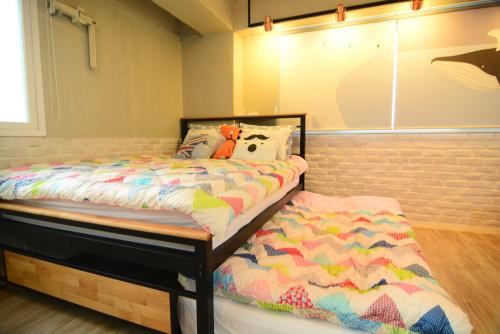 a bedroom with a bed and a pillow on it at Residence Unicorn in Seoul