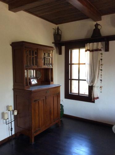 a room with a wooden cabinet and a window at Selimiye Houses in Selimiye