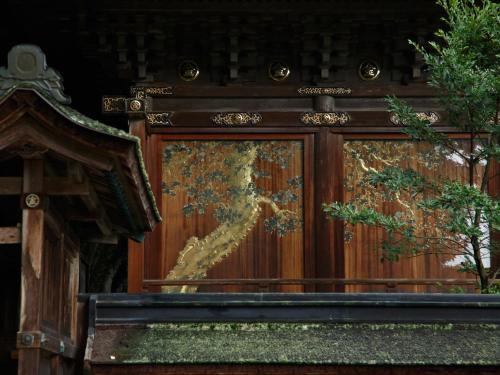 a painting of a tree on a wooden fence at Kotohira Kadan in Kotohira