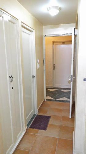 a hallway with two doors and a tile floor at Hotel Rangoli in Jaipur