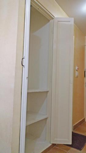 a white closet with shelves in a room at Hotel Rangoli in Jaipur