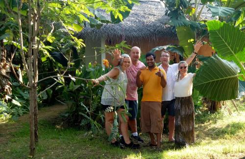 a group of people standing in front of a tree at Lake Cabin in Polonnaruwa