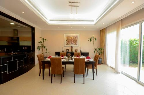 a dining room with a table and chairs at Coral Boutique Villas in Dubai