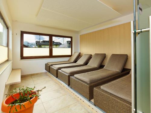 a living room with three couches and a window at Gasthof Hotel Post in Sautens