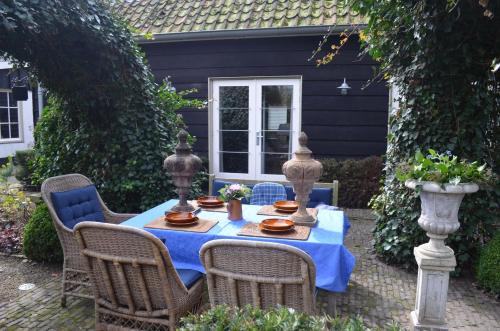 a table with a blue table cloth on a patio at The Barn in Sleeuwijk