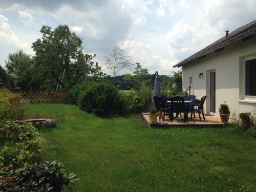a patio with a table and chairs in a yard at Ferienlandhaus Riehenhaar in Telgte