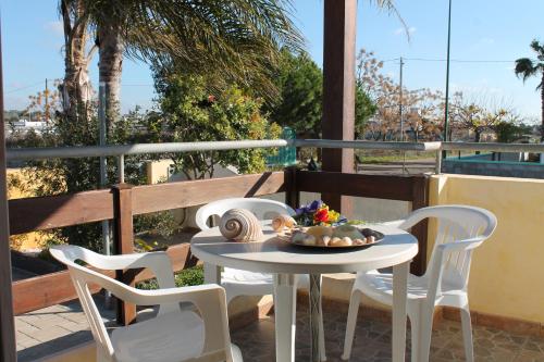 a table and two chairs on a balcony with a table at Residence Jonico in Torre Suda