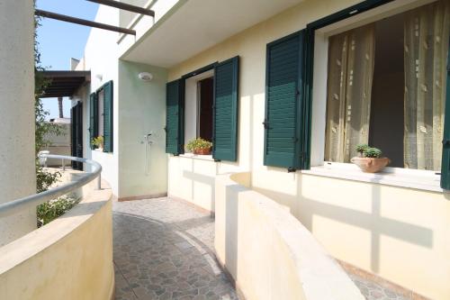 a hallway of a house with green shutters at Residence Jonico in Torre Suda