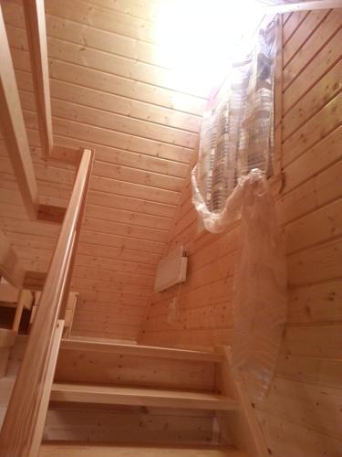 a woman is standing in a sauna at Ow Bursztynek in Rusinowo