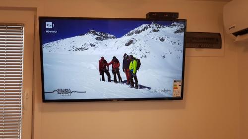 a flat screen tv hanging on a wall at Floating Sea House Portorose in Portorož