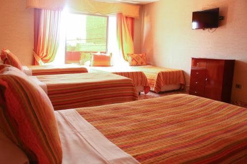 Postel nebo postele na pokoji v ubytování Hotel Costa Pacifico
