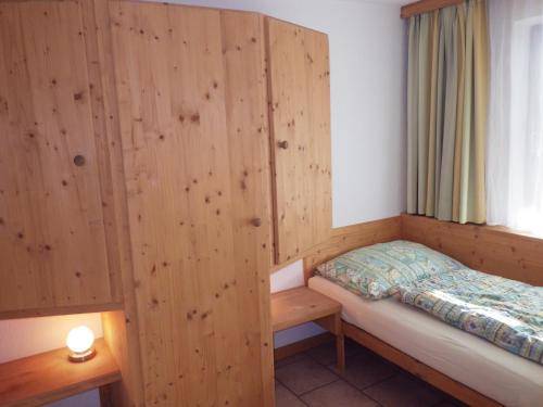 a small room with a bed and a window at Haus Thomas in Telfs