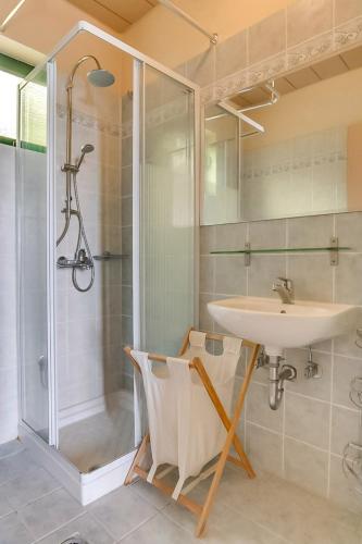 a bathroom with a sink and a shower at Villa Apostolata in Skala