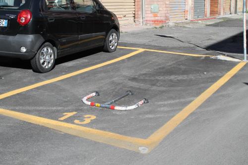 a car parked in a parking lot at Affittacamere Golfo Della Luna in La Spezia