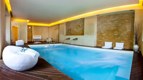 a large swimming pool in a hotel room at Giovanna Regina Hotel in Gabicce Mare