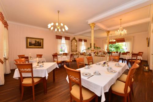 a dining room with white tables and chairs at Hotel Marienhof in Bad Wörishofen