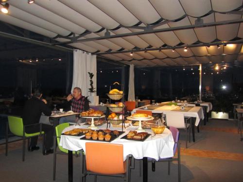 a table with food on it in a restaurant at Hotel Arbe in Mutriku