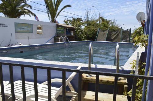 a swimming pool on the balcony of a house at Cabañas Hecmar in Pichilemu