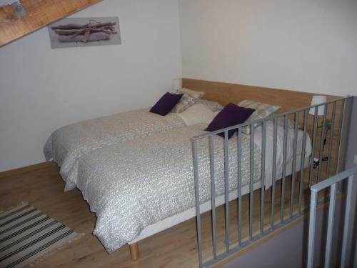 a bedroom with a bed with a metal railing at Gite 4* L'Orée des Fleurs in Grézillé