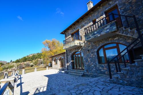 a stone building with a staircase on the side of it at Karyatis Resort in Synikia Mesi Trikalon