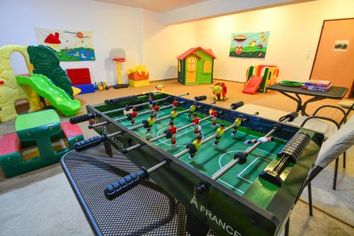 a play room with a foosball table and toys at Karyatis Resort in Synikia Mesi Trikalon