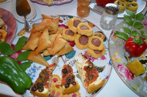 a plate of food with pizza and vegetables on a table at Rozmari and Spa in Agia Galini