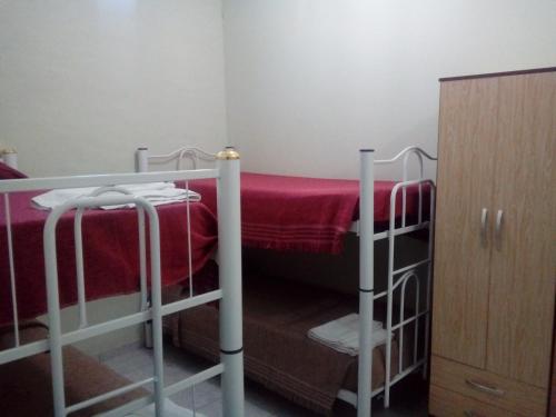 a small room with two bunk beds and a cabinet at Alojaserve in San Rafael