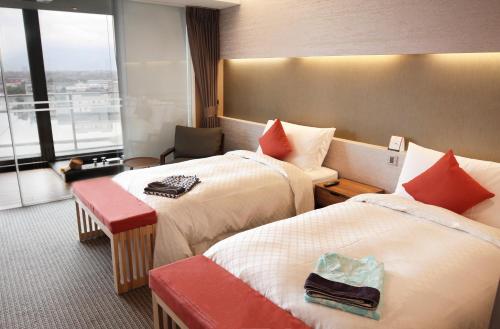 a hotel room with two beds and a window at Dancewoods Hotel in Wujie