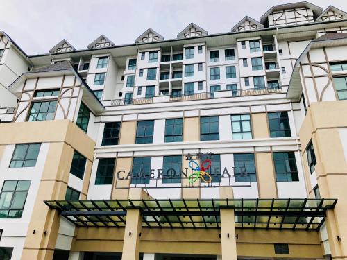 a building with a sign on the front of it at ATS Cameron Hotel & Apartments in Cameron Highlands