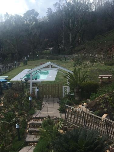 a swimming pool in a yard with a fence at Lagoon View Villa in Knysna