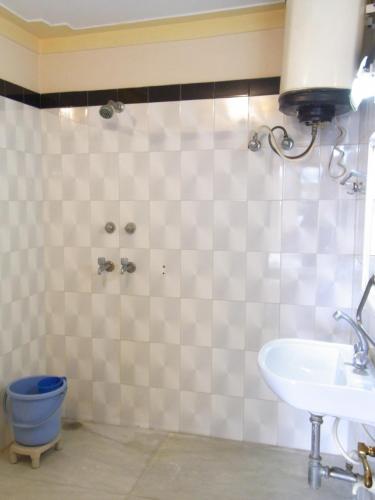 a bathroom with a sink and a toilet at Momotaro House in Bodh Gaya