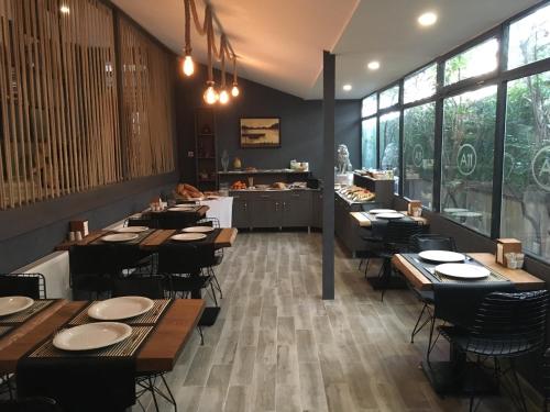 a restaurant with wooden tables and chairs and windows at A11 Hotel in Istanbul