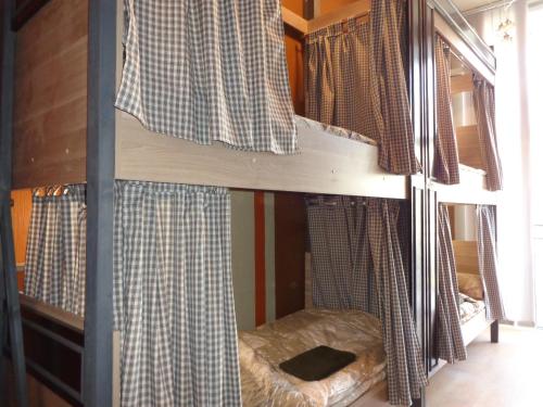 two bunk beds in a room with a window at Hostel Balkonsky in Rostov on Don