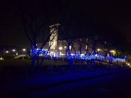 a row of trees decorated with blue lights at night at Jade Garden Hote in Gukeng