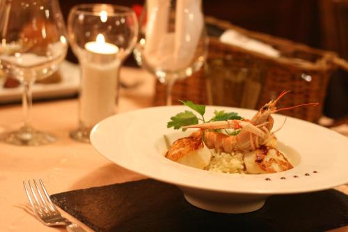 a plate of food with shrimp on a table at Hôtel Aster Restaurant Aux Arcades in Briey