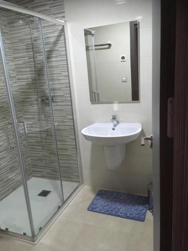 a bathroom with a shower and a sink and a mirror at Terrazas de Campoamor Barbara in Playas de Orihuela